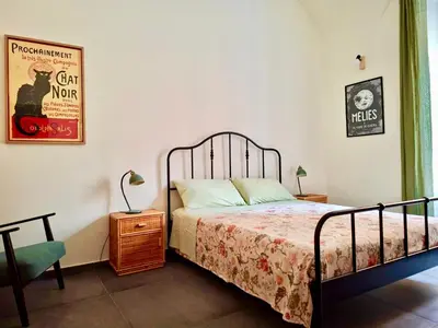 a bedroom with a bed and a table and a chair at Casa Sommeiller in Rome