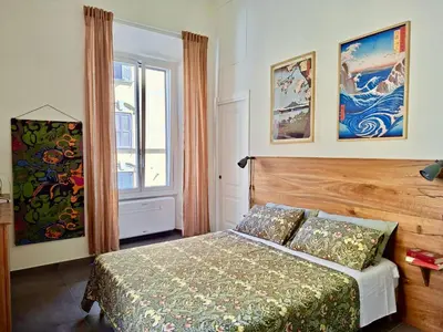 a bedroom with a bed and a window at Casa Sommeiller in Rome