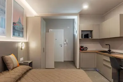 a room with a kitchen and a bed in a room at GuestHost - Studio Apartment MM Cipro Rome in Rome