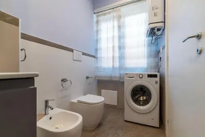 a bathroom with a washing machine and a sink at GuestHost - Studio Apartment MM Cipro Rome in Rome