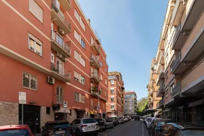 a city street with cars parked on the sides of buildings at GuestHost - Studio Apartment MM Cipro Rome in Rome