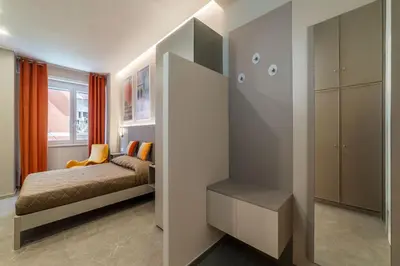 a bedroom with a bed and a closet at GuestHost - Studio Apartment MM Cipro Rome in Rome