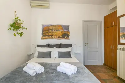 a bedroom with a large bed with two pillows at BB Trastevere Station - Room2 in Rome