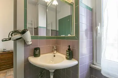 a bathroom with a sink and a mirror at BB Trastevere Station - Room2 in Rome