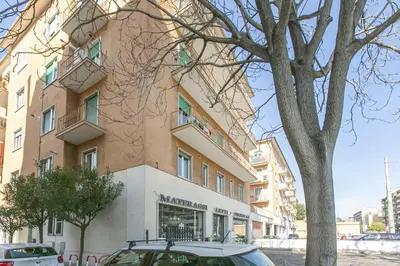 a building with a car parked in front of it at BB Trastevere Station - Room3 in Rome