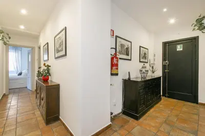 a hallway with a white wall and a black door at BB Trastevere Station - Room3 in Rome