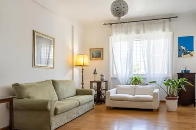 two beds in a room with a painting on the wall at Sempione-Metro B, Vintage Apartment, AC, WiFi in Rome