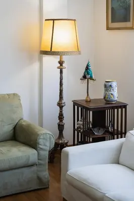 a living room with a couch and a chair at Sempione-Metro B, Vintage Apartment, AC, WiFi in Rome