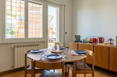 a living room with a couch and a lamp at Sempione-Metro B, Vintage Apartment, AC, WiFi in Rome