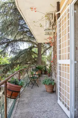 a wooden table with four chairs and plates on it at Sempione-Metro B, Vintage Apartment, AC, WiFi in Rome