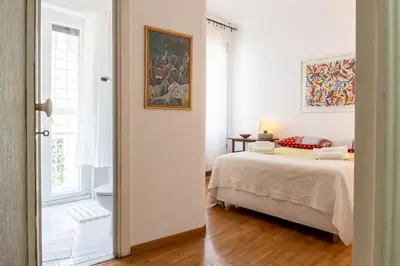 a bedroom with a bed and a painting on the wall at Sempione-Metro B, Vintage Apartment, AC, WiFi in Rome