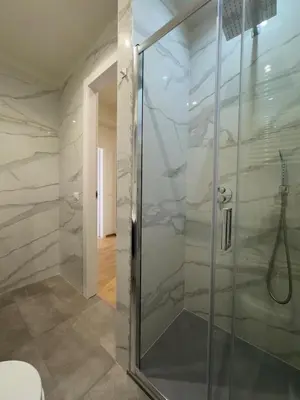 a shower with a glass door in a bathroom at Casa Emma in Rome