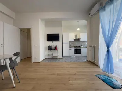 a living room with a table and a blue curtain at Casa Emma in Rome