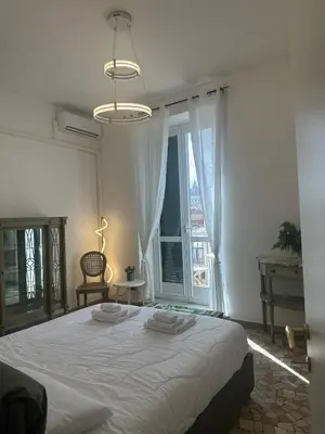 a bedroom with a large bed and a large window at Casa di Andrea 2 in San Pietro in Rome