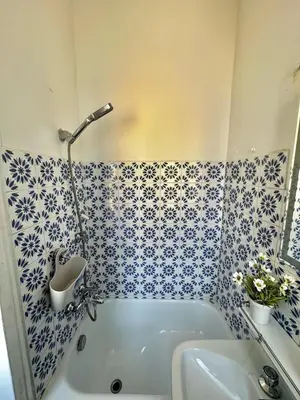 a blue and white bathroom with a tub and a sink at Casa di Andrea 2 in San Pietro in Rome