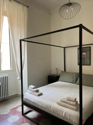 a bedroom with a canopy bed with towels on it at RL Apartment in Rome