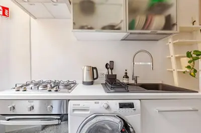 a kitchen with a washing machine and a sink at RL Apartment in Rome