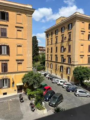 a group of cars parked in a parking lot next to buildings at RL Apartment in Rome