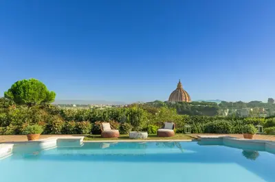 a swimming pool with a view of the city at Torre della Luna Roma Lusso, Privacy e Piscina con Vista su San Pietro in Rome