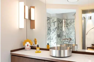 a bathroom with two sinks and a mirror at Torre della Luna Roma Lusso, Privacy e Piscina con Vista su San Pietro in Rome