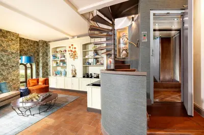 a kitchen and living room with a couch and a table at Torre della Luna Roma Lusso, Privacy e Piscina con Vista su San Pietro in Rome
