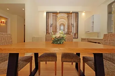a dining room table with chairs and a vase of flowers at Gioia's Home in Rome