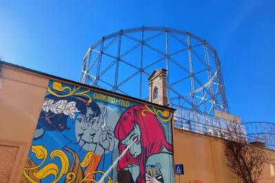 a roller coaster with a mural on the side of a building at Gioia's Home in Rome