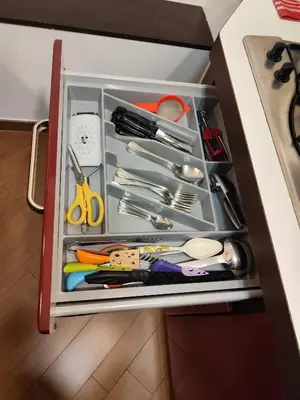 a drawer in a cabinet filled with utensils at Next Stop St Peter - Apartment in Rome