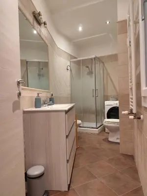 a bathroom with a sink and a shower and a toilet at Next Stop St Peter - Apartment in Rome