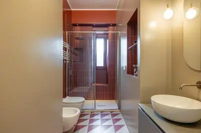 a bathroom with a sink and a toilet and a shower at Stylish 3BR between Vatican & City Center in Rome