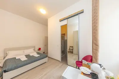 a bedroom with a bed and a desk and a chair at San Pietro View Boutique Rooms in Rome