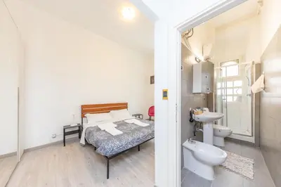 a bedroom with a bed and a sink and a toilet at San Pietro View Boutique Rooms in Rome