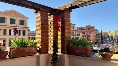 a brick wall with potted plants on a balcony at Elegant suite near the Vatican in Rome