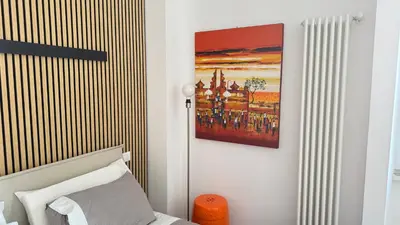 a bedroom with a bed and a painting on the wall at Elegant suite near the Vatican in Rome