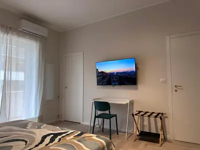 a bedroom with a bed and a television on the wall at Parthenope Vatican House in Rome