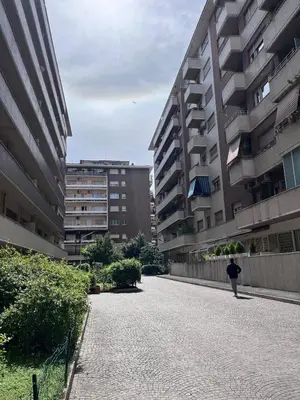 a person walking down a street between two buildings at Parthenope Vatican House in Rome