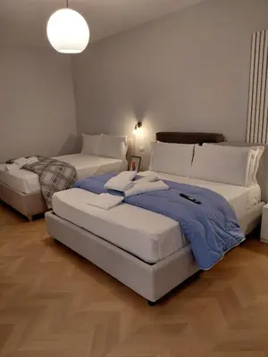 a bedroom with two beds and a lamp at Guest House - Vatican Rome in Rome