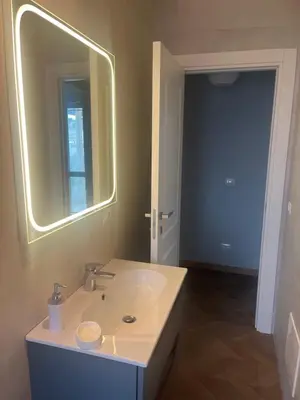 a room with two beds and a pendant light at Guest House - Vatican Rome in Rome