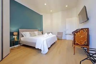 a bedroom with a white bed and a blue wall at 4BNB - Flaminio Modern Apartment in Rome