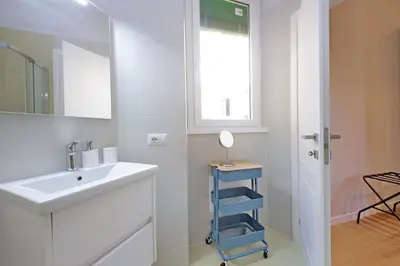 a white bathroom with a sink and a mirror at 4BNB - Flaminio Modern Apartment in Rome