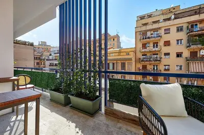 a balcony with two plants in pots on a building at Art Suite San Giovanni in Rome