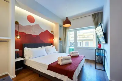 a bedroom with a bed with two towels on it at Art Suite San Giovanni in Rome