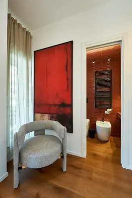 a bathroom with a chair and a bath tub at Art Suite San Giovanni in Rome