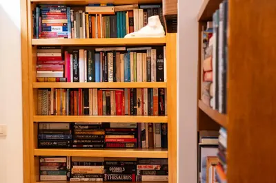 a book shelf filled with lots of books at Residenza a Monti in Rome
