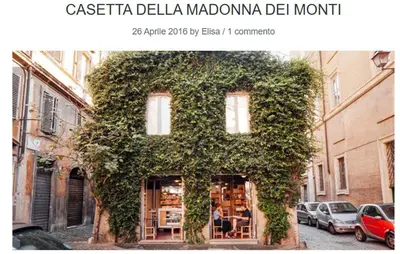 a building covered in ivy on the side of a street at Residenza a Monti in Rome