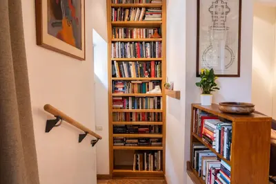 a book shelf filled with books next to a staircase at Residenza a Monti in Rome