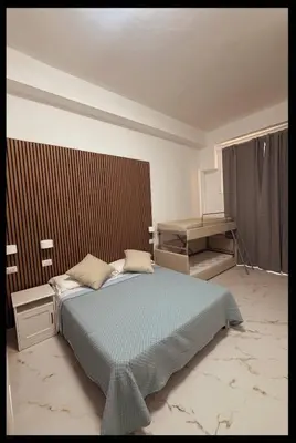 a small bedroom with a bed and a chair at BeLLa Vista in Rome