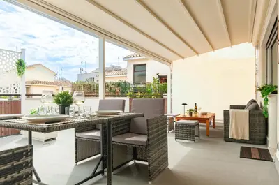 an outdoor patio with a dining table and chairs at L'Attico di Katia in Rome