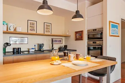 a kitchen with a wooden table with orange juice on it at L'Attico di Katia in Rome