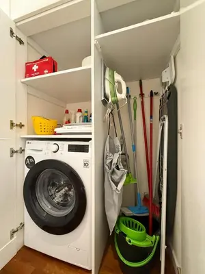 a laundry room with a washing machine in a closet at L'Attico di Katia in Rome